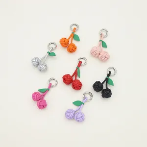 Assorted handmade PU leather cherry charms for bags and keychains in vibrant colors