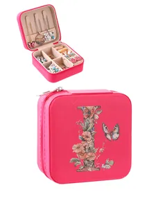 Vibrant pink portable jewelry box featuring a floral letter I print and secure zipper