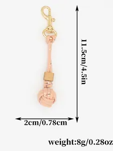 Detailed size guide for this pink hand-woven ball keychain featuring a wooden bead and gold clasp