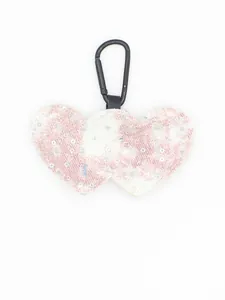 Detail of pink plaid denim heart keychain with silver sequins and black carabiner.