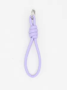 Detail of a minimalist lilac purple PU leather braided keychain with silver ring.