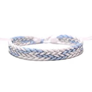 Close-up detail of hand-woven blue and white braided wax rope bracelet for summer