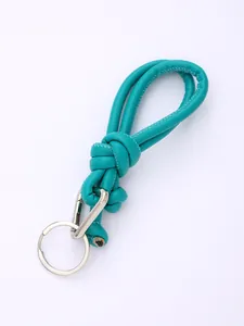 Detail of turquoise PU leather braided strap with silver key ring and carabiner.