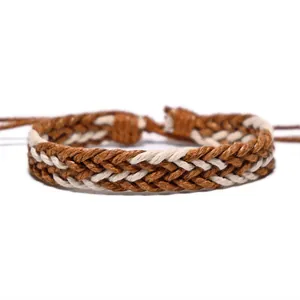 Close-up of handmade brown and white braided wax rope bracelet with ethnic style