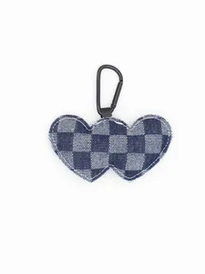 Detailed view of a blue and white checkered denim double heart keychain with clip