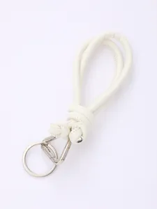 Detail view of a handmade white knotted PU leather keychain with silver hardware.