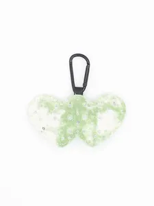 Macro detail of a green denim plaid double heart keychain with sparkling sequin accents