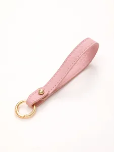 Close-up of pink lychee pattern leather keychain strap with gold hardware ring