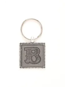Close-up of vintage style letter B embossed keychain in silver and grey finish