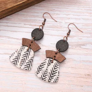 Detail showing the chevron pattern on layered cork and wood bohemian earrings.
