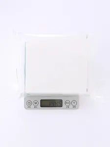 Detailed view of a minimalist white jewelry storage box weighing 144.5 grams on a scale