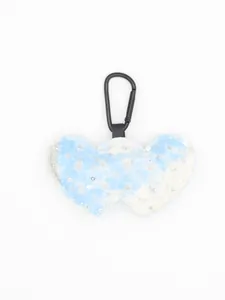 Detailed view of blue denim heart keychain with sparkling silver sequins and black clip