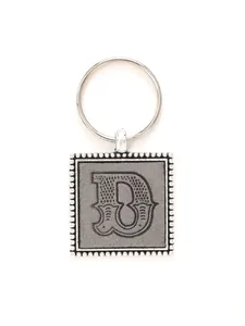 Close-up detail of square zinc alloy keychain with embossed vintage leather letter B