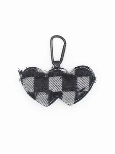 Macro detail of double heart checkered denim keychain with black metal carabiner