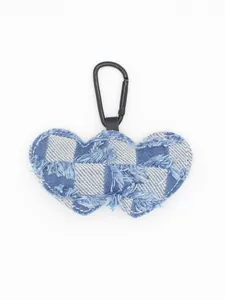 Detailed view of heart-shaped denim keychain featuring checkered pattern and frayed edges