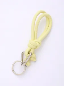 Close-up of yellow hand-woven PU leather keychain with silver metal clip and ring