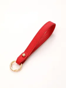 Red textured leather keychain wrist strap with elegant gold-tone metal hardware