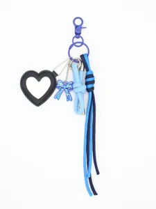 Detail of black heart leather mirror and blue bow charm woven keychain bag pendant