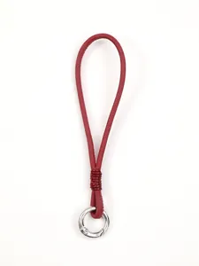 Close-up view of a red leather phone wrist strap lanyard with a silver metal ring