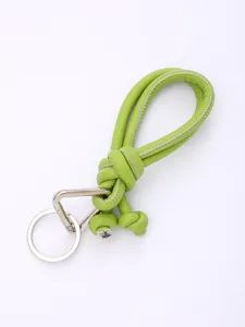 Close-up of green handmade braided PU leather lanyard with silver metal ring