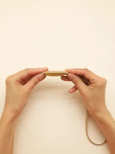 Detailed side view of the slim PU leather donut keychain showing quality multi-layer construction