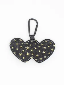 Detail of black denim double heart keychain with gold star sequins and carabiner