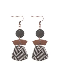 Detail of bohemian geometric cork earrings featuring multi-layered wood and striped patterns.