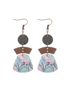 Detail view of bohemian multi-layer geometric cork earrings with floral print pattern
