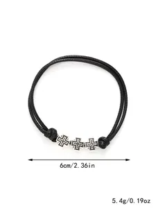 Close-up of black braided rope bracelet with silver cross charms and dimensions
