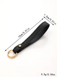 Detail view of black leather keychain strap showing dimensions 14cm x 1.3cm and 9.9g weight