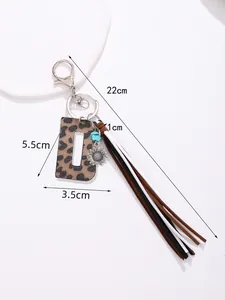 Detail shot of leopard print letter D keychain with sunflower and long tassel.
