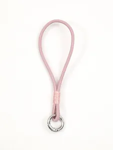 Detail of a pink handmade leather phone wrist strap with silver ring clasp.
