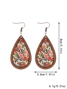 Macro view of bohemian wood teardrop earrings with floral pattern and dimensions