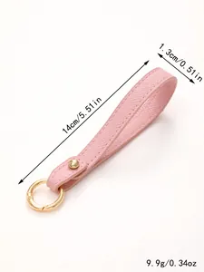 Detailed view of pink leather wristlet strap with dimensions 14cm and 1.3cm and 9.9g weight