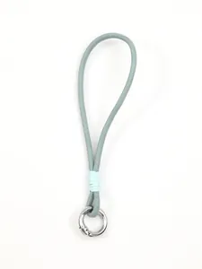 Close-up of blue leather phone wrist strap with silver metal ring and thread detail