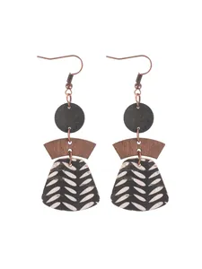 Detailed view of bohemian multi-layer cork earrings with geometric wood accents