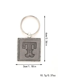 A detail view showing the dimensions and weight of the leather embossed 'T' keychain.