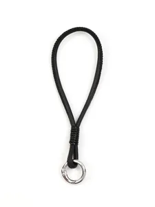 Detail of handmade black braided phone lanyard wristband with silver metal ring clasp.