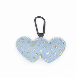Stylish denim double heart keychain featuring golden star prints and black carabiner