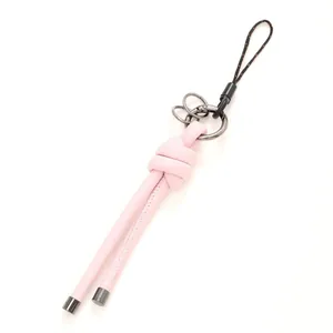 Elegant pink leather knotted keychain and bag charm with gunmetal hardware accents