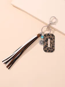 Close-up of leopard print leather keychain with multi-color tassel and sunflower charm