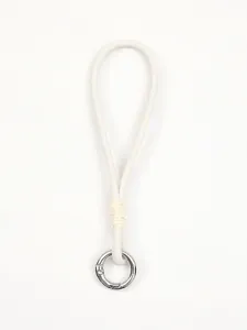 Close-up view of a white leather phone wrist strap featuring a silver metal ring