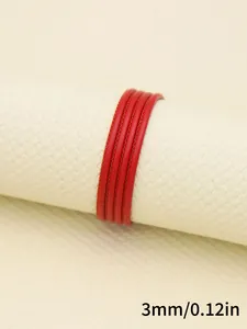 Macro detail view of 3mm red faux sheepskin stitched cord for DIY jewelry making crafts