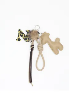 Vista dettagliata del set ciondolo per borsa con lettera M leopardata e giraffa PU