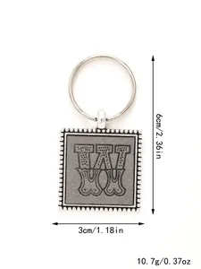 Detailed view of a square zinc alloy keychain with an embossed letter W leather inlay.