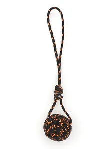 Macro view of handmade black and orange polyester monkey fist knot keychain pendant