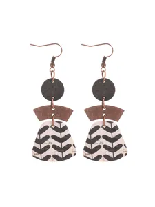 Detailed view of bohemian multi-layered earrings with geometric cork and leaf pattern