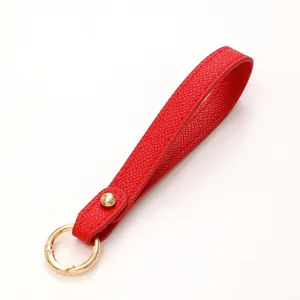 Vibrant red leather wristlet keychain with elegant gold spring ring clasp