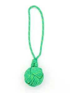 Detailed view of handmade green monkey fist knot pendant with durable braided rope.