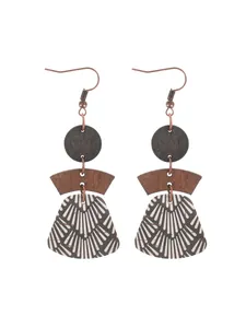Detailed view of bohemian layered earrings featuring geometric cork and wood pendants.